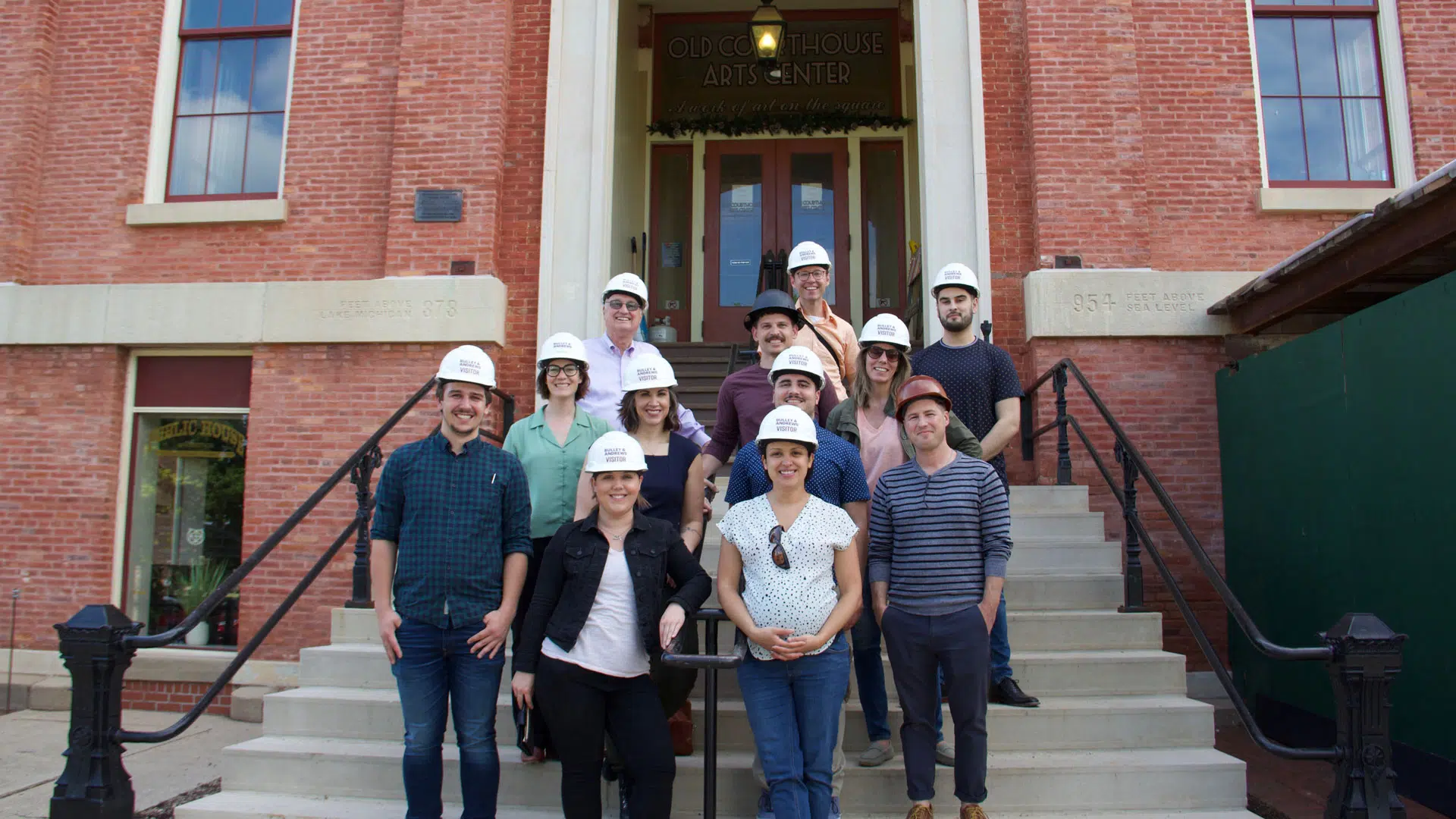The Studio GWA team is pictured in front of the main entrance of the Old McHenry County Courthouse in Woodstock, Illinois.