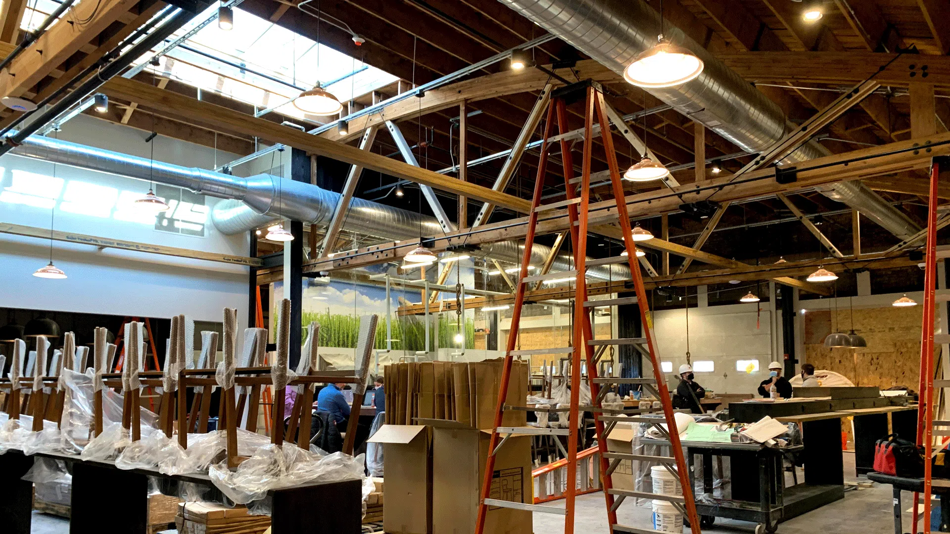 Image shows an indoor dining area and bar with guests at the Lock and Mule in Lockport, Illinois.